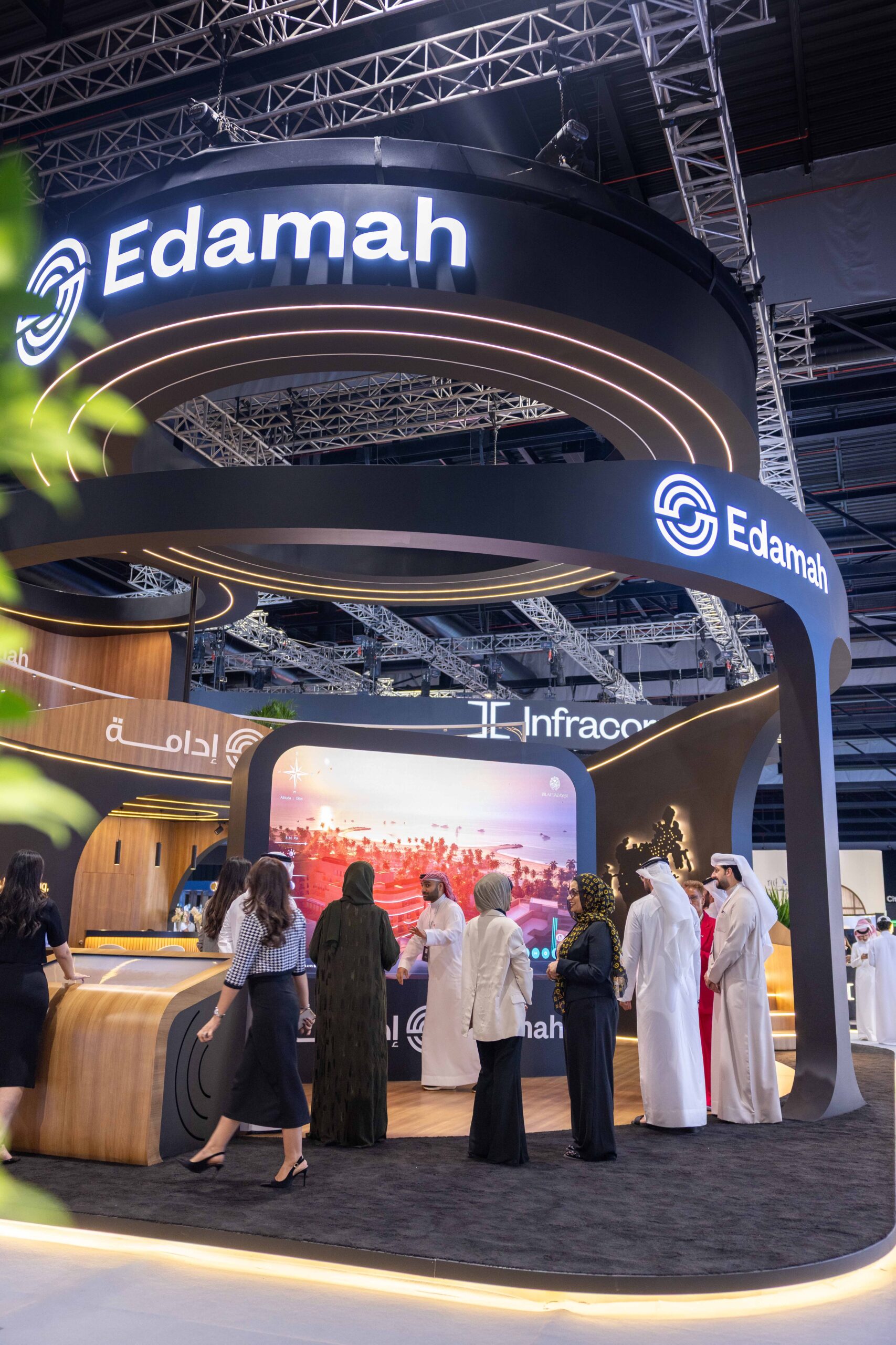 Visitors at the Edamah stand exploring the development on a large CityView screen